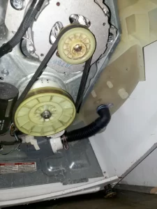 Maytag washing machine drive motor and pulleys  shown for inspection.